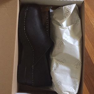 Sanita black textured oiled leather clogs